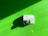 A hand dryer is mounted on a vibrant green wall. The hand dryer is white with a shiny metallic nozzle and casts a distinct shadow on the wall, indicating a light source from the upper left corner.