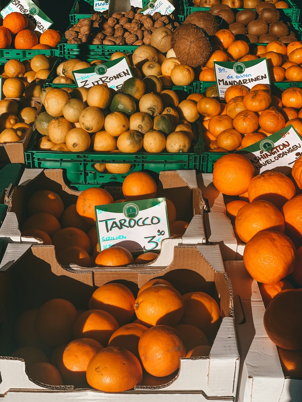 orange fruits on black plastic crate