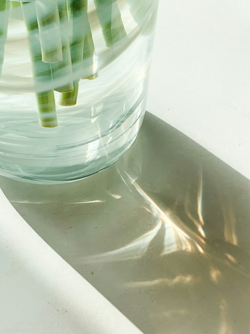 clear glass cup with green straw