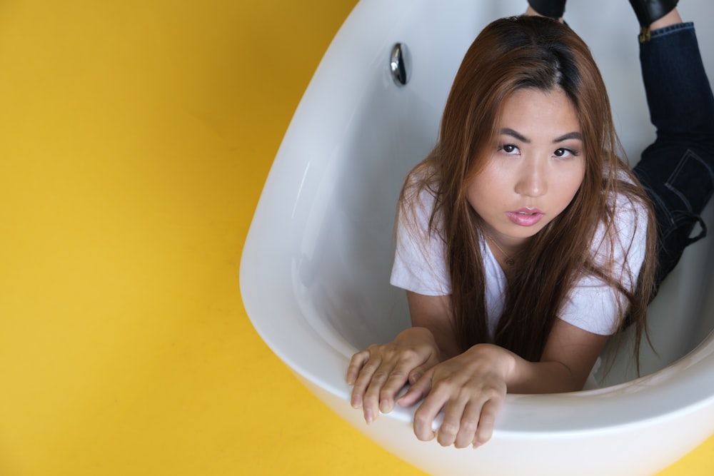 woman in white sleeveless shirt on bathtub