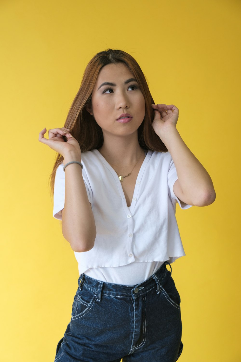 woman in white button up shirt and blue denim jeans