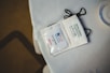 A close-up of a beautifully designed event badge with a lanyard.