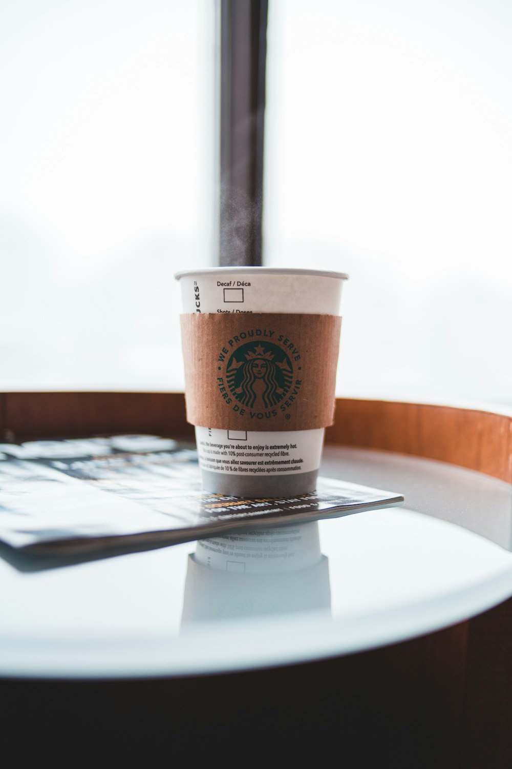 white and brown disposable cup on white round plate