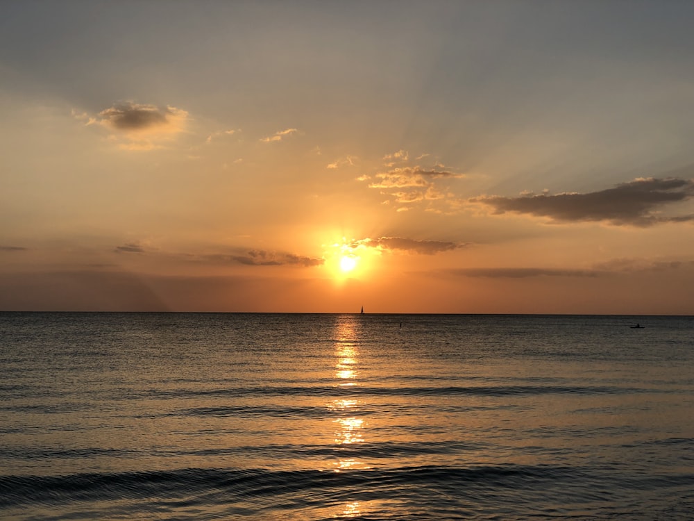 body of water during sunset