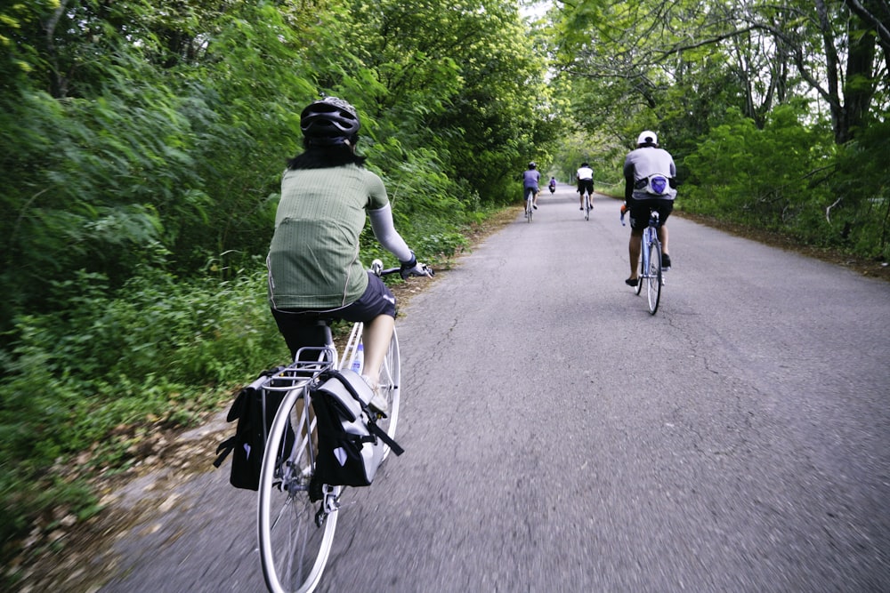 people riding bicycle on road during daytime