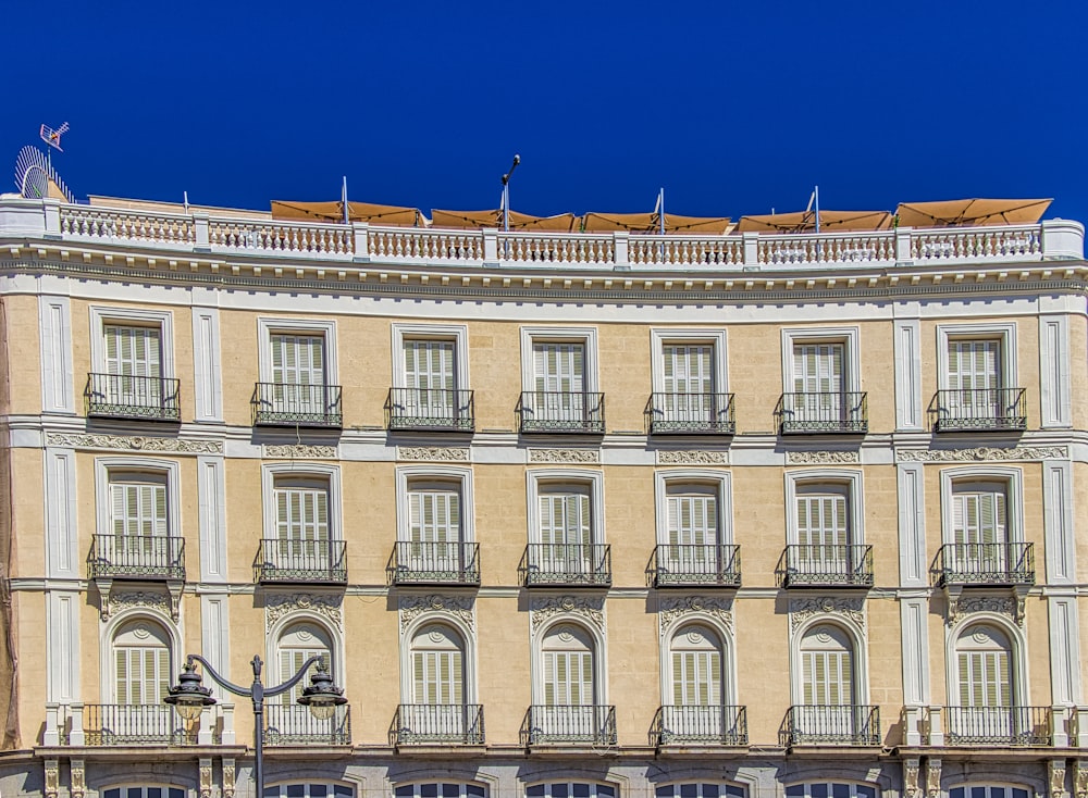 beige concrete building under blue sky during daytime