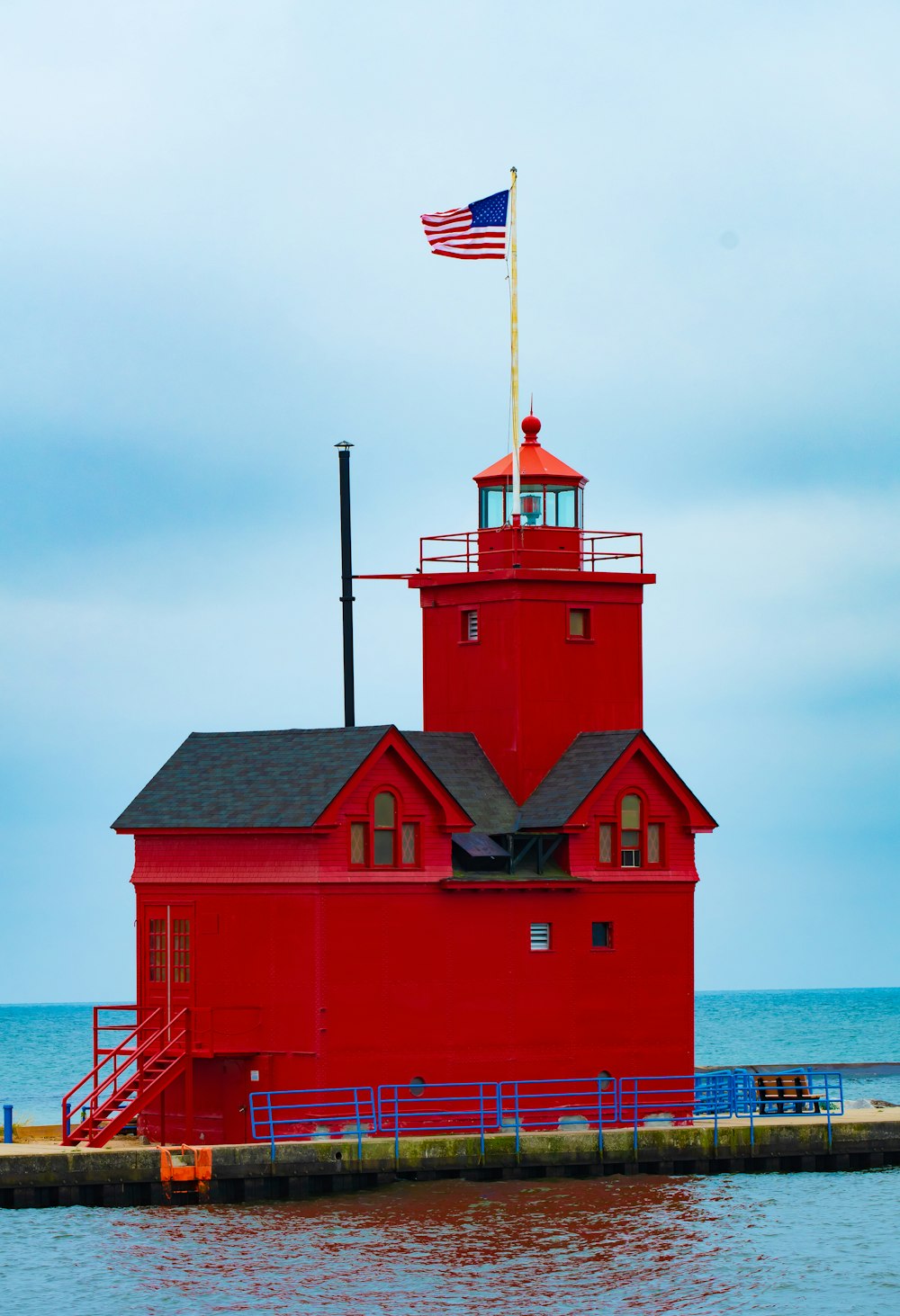 red and white house with flag of us a on top