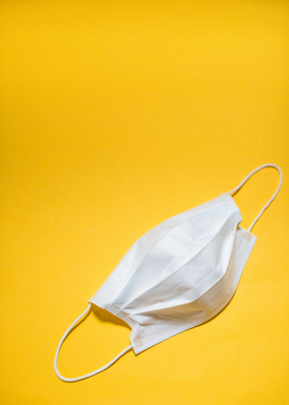 white brassiere on yellow textile