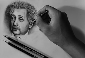A close-up of a hand sketching a portrait with intricate details.