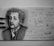 A detailed pencil drawing of a person famous for their theory of relativity, surrounded by various mathematical equations and diagrams related to physics. The drawing showcases detailed facial features and expressions, accompanied by carefully written scientific notes and quotes. Three pencils are placed beside the drawing.