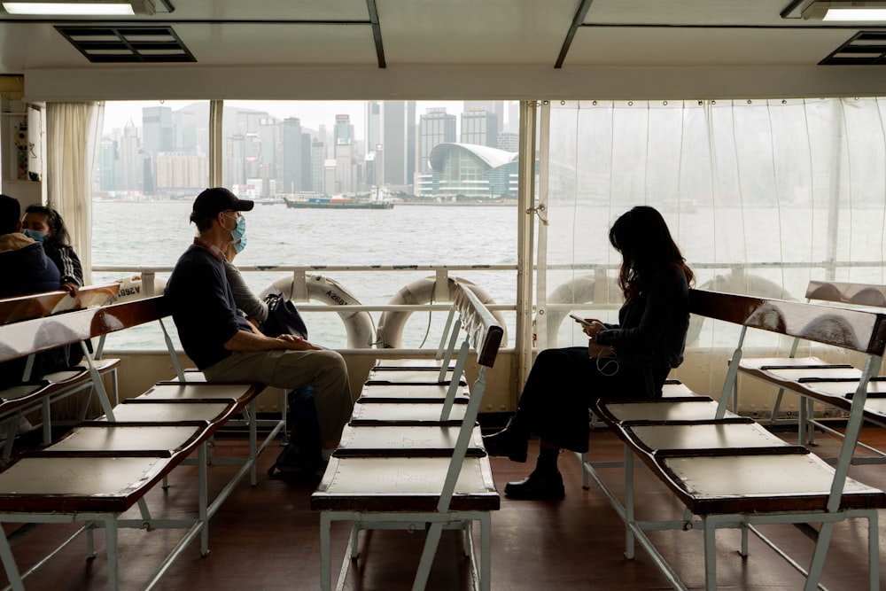 man and woman sitting on white wooden chair