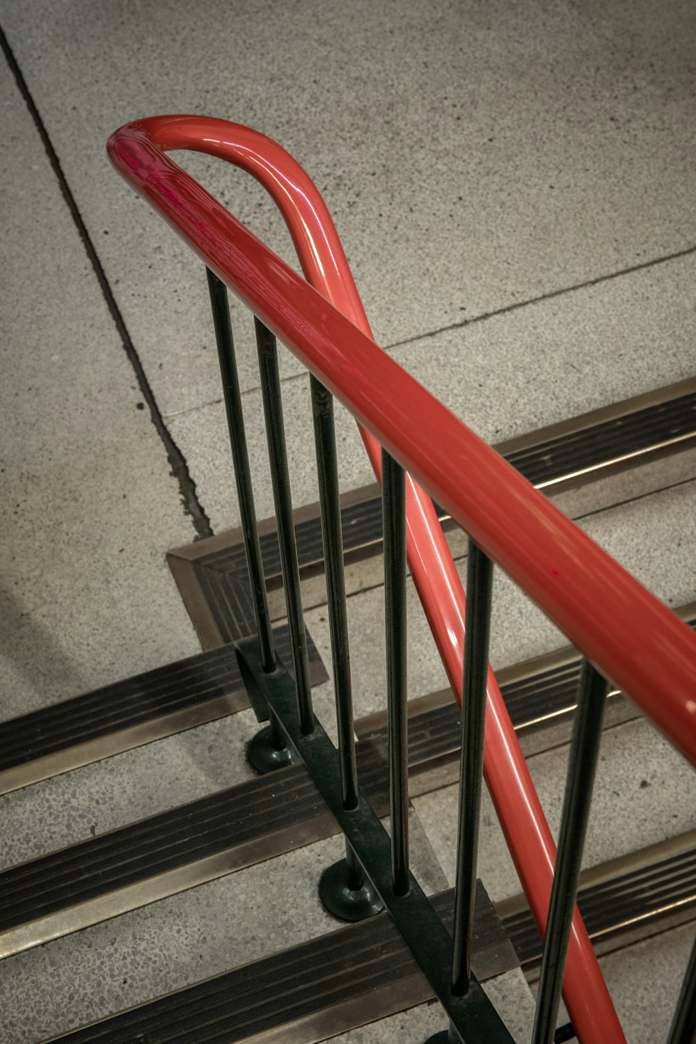 red metal railings on gray concrete floor