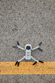 white and yellow drone on gray textile