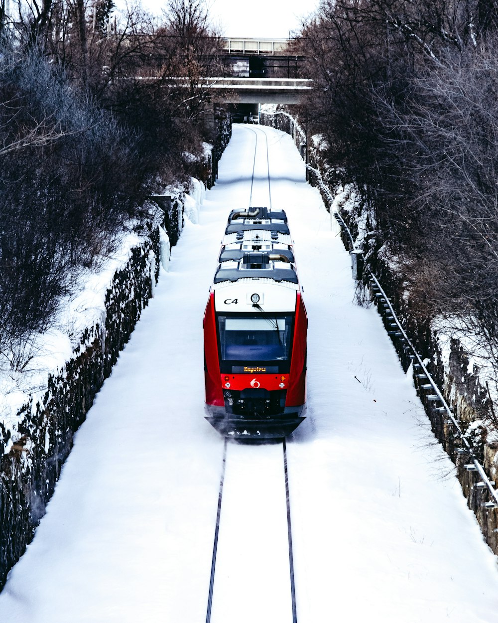 red car on snow covered road during daytime