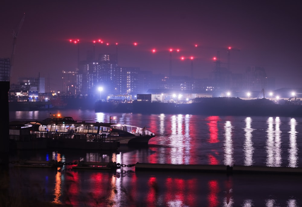 body of water near city buildings during night time