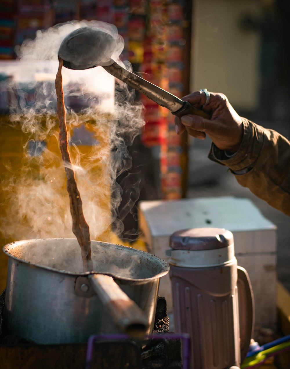 person pouring water on stainless steel bucket