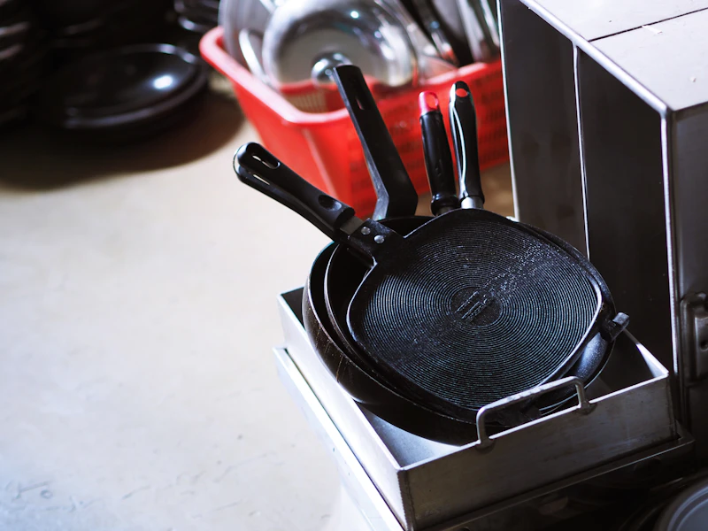 A cast iron skillet beside a non-stick pan