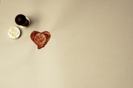 A handwritten love letter resting on a wooden desk with a wax seal.