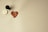 A wax seal with a heart shape and the words 'with love' is stamped on a light-colored surface. A handle, likely part of a seal stamp, rests nearby along with the metal stamp component showing the inverted phrase.