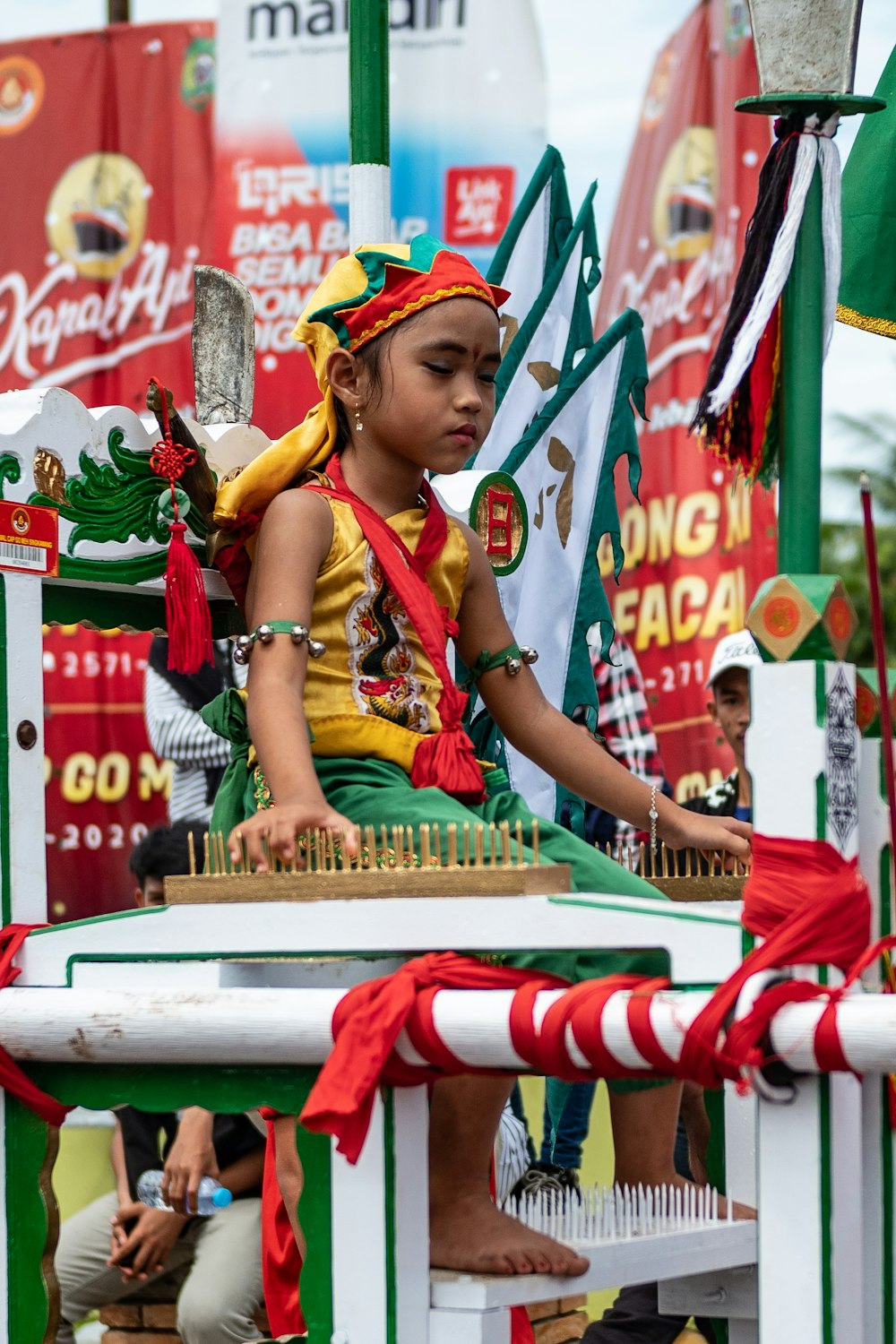 woman in green and yellow floral dress sitting on red and white boat during daytime