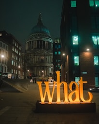 yellow love freestanding letters on street during nighttime