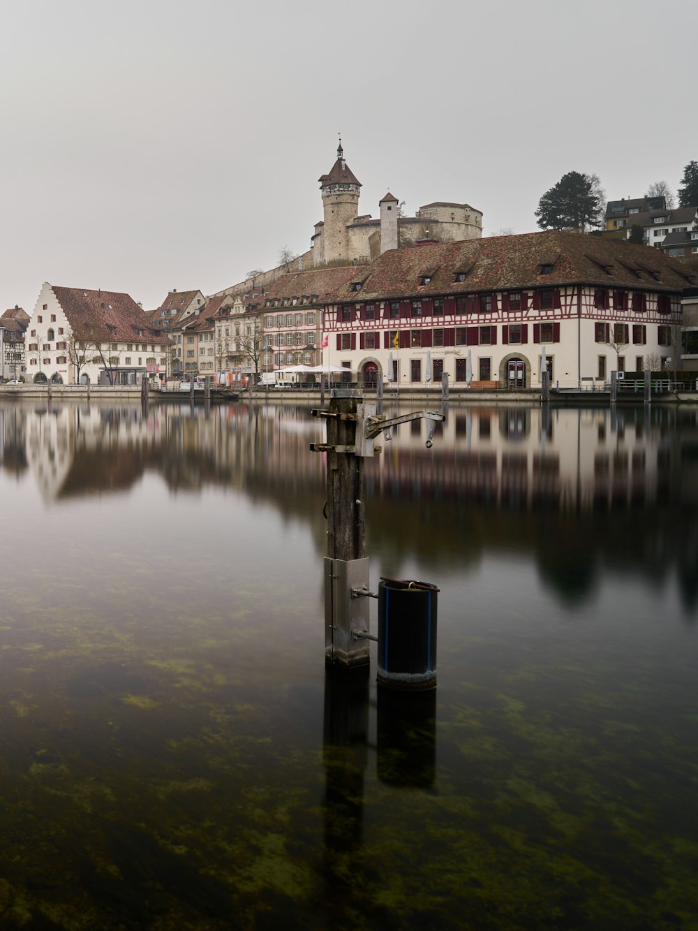 brown concrete building near body of water during daytime