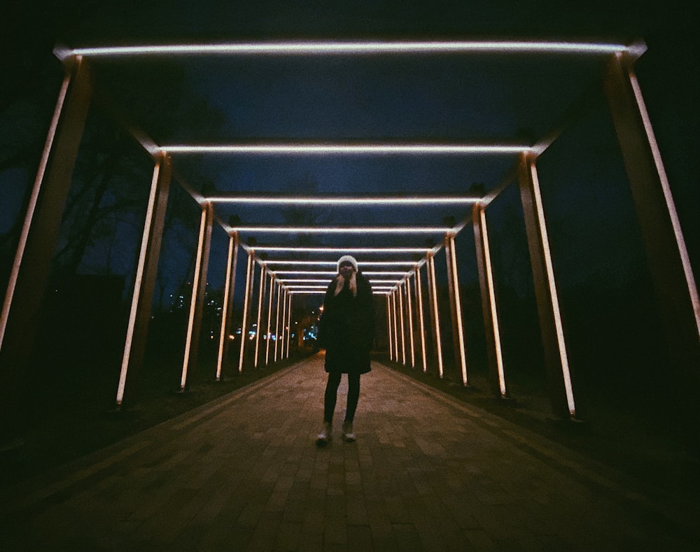 man in black jacket walking on pathway