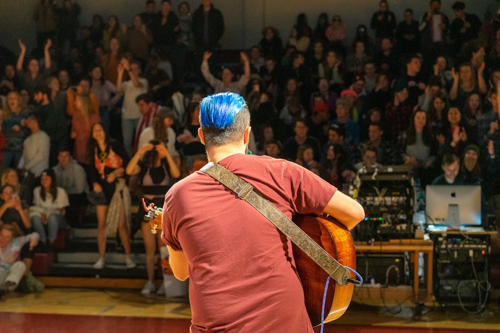 Get noticed: man playing guitar standing on stage