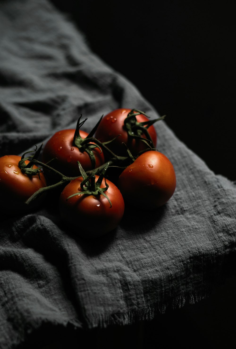 red tomato on black textile