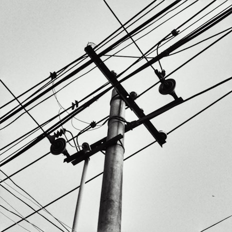 Close-up aerial image displaying intricate telecom cabling over challenging terrain.