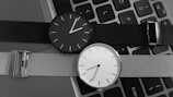 black and white analog watch at 10 00