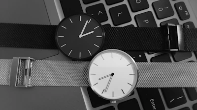 black and white analog watch at 10 00
