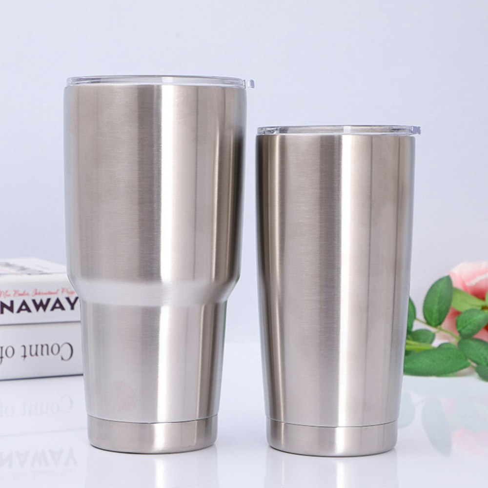 stainless steel cup on white and red floral textile