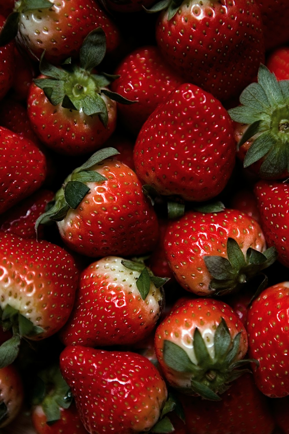 red strawberries on green leaves