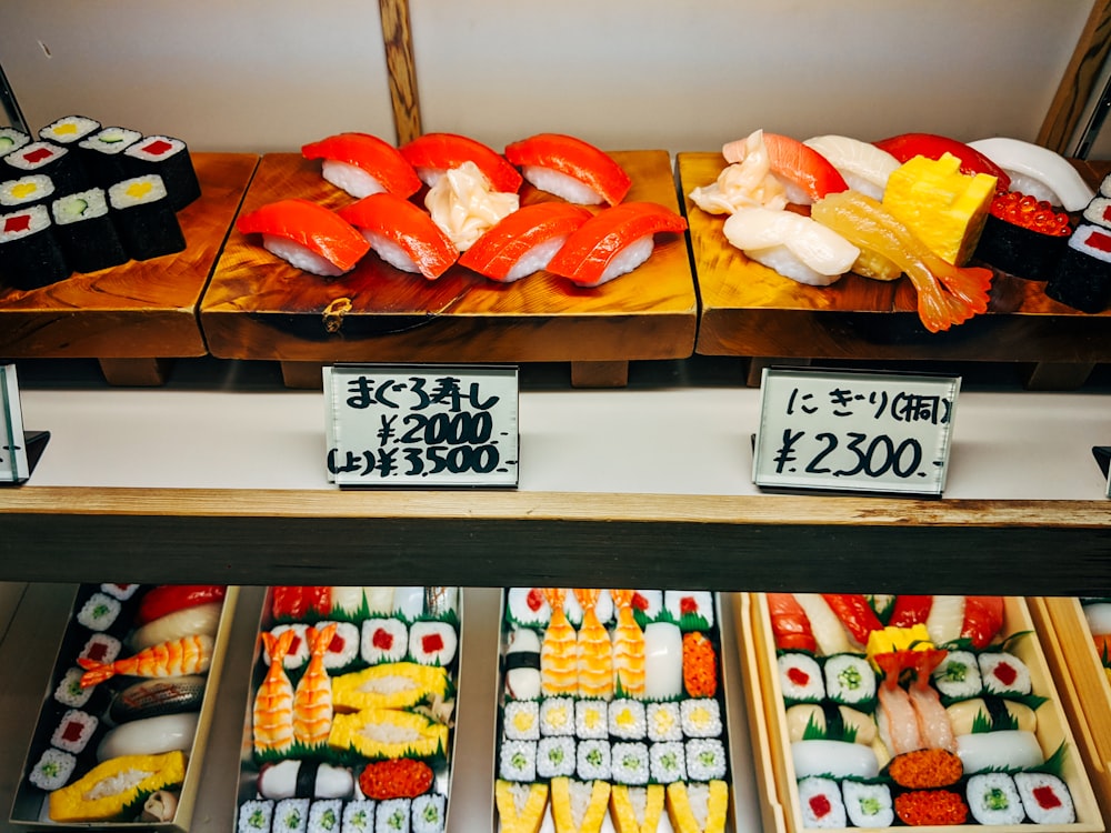 assorted sushi on white wooden shelf