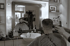 Man getting a stylish fade haircut in a modern barbershop