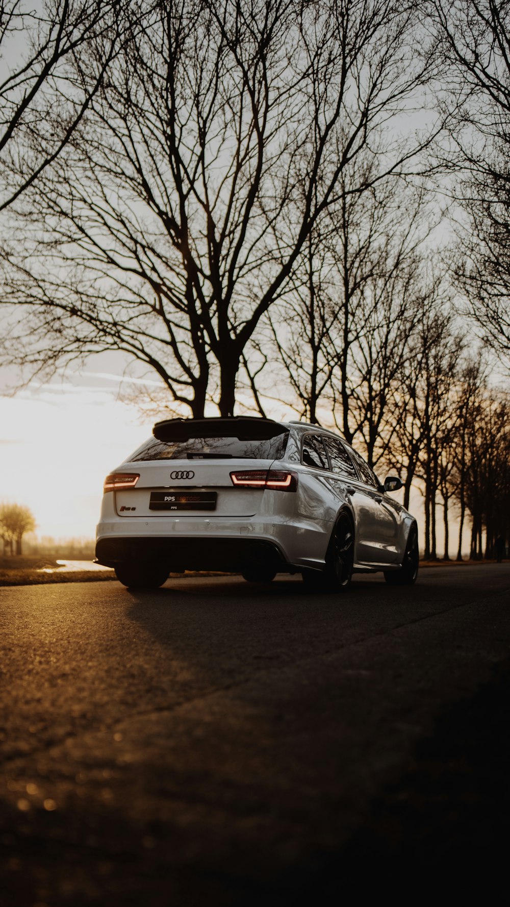 white bmw car on road during sunset