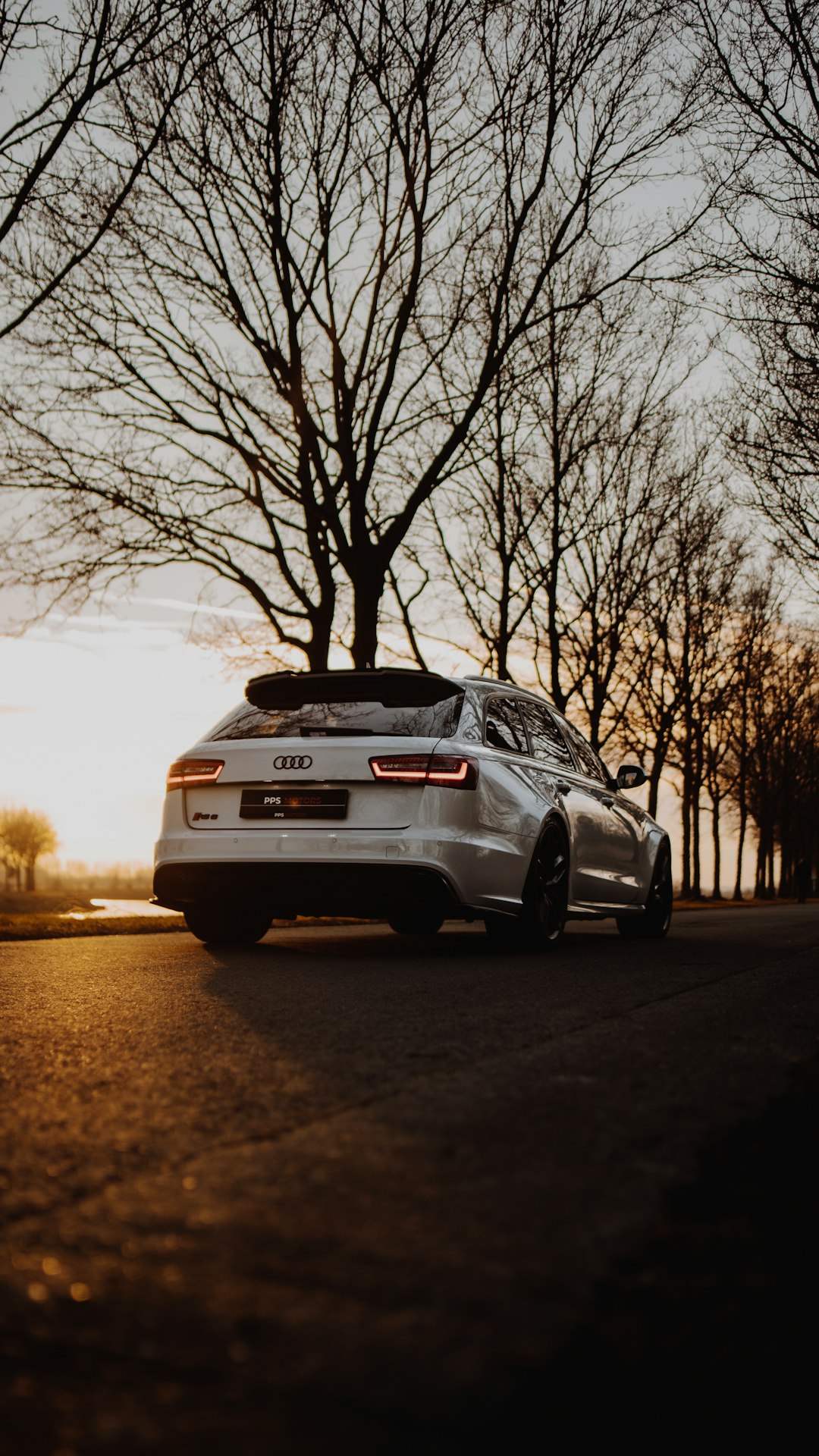 white bmw car on road during sunset