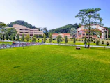 Wide shot of the Agricultural University of Tirana campus with green surroundings.