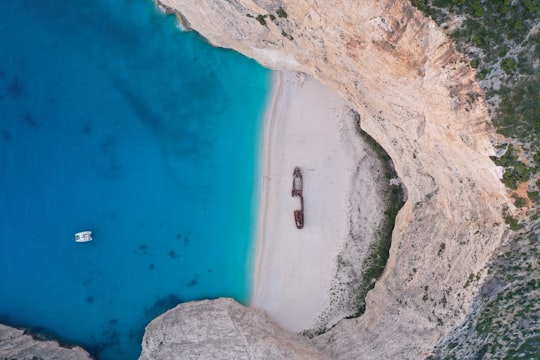 person surfing on blue sea during daytime in Zakynthos Greece