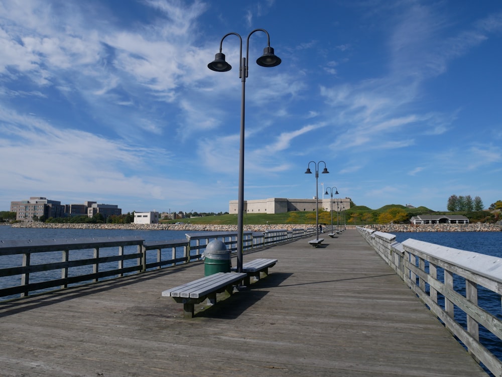 black street light on gray wooden dock during daytime