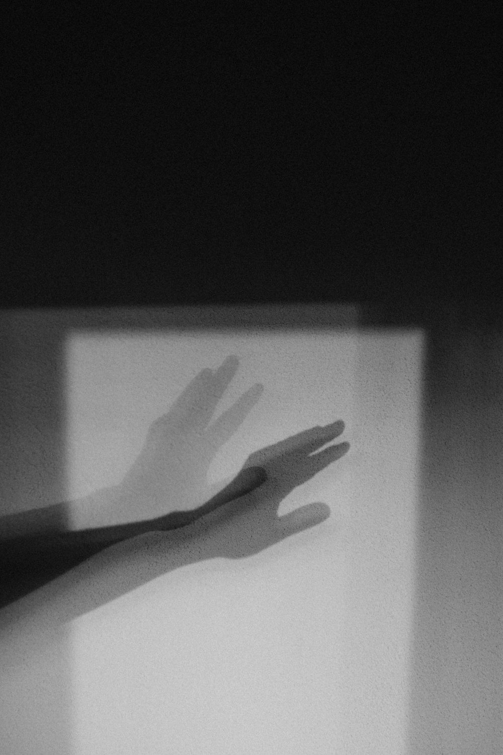 persons hand on white textile