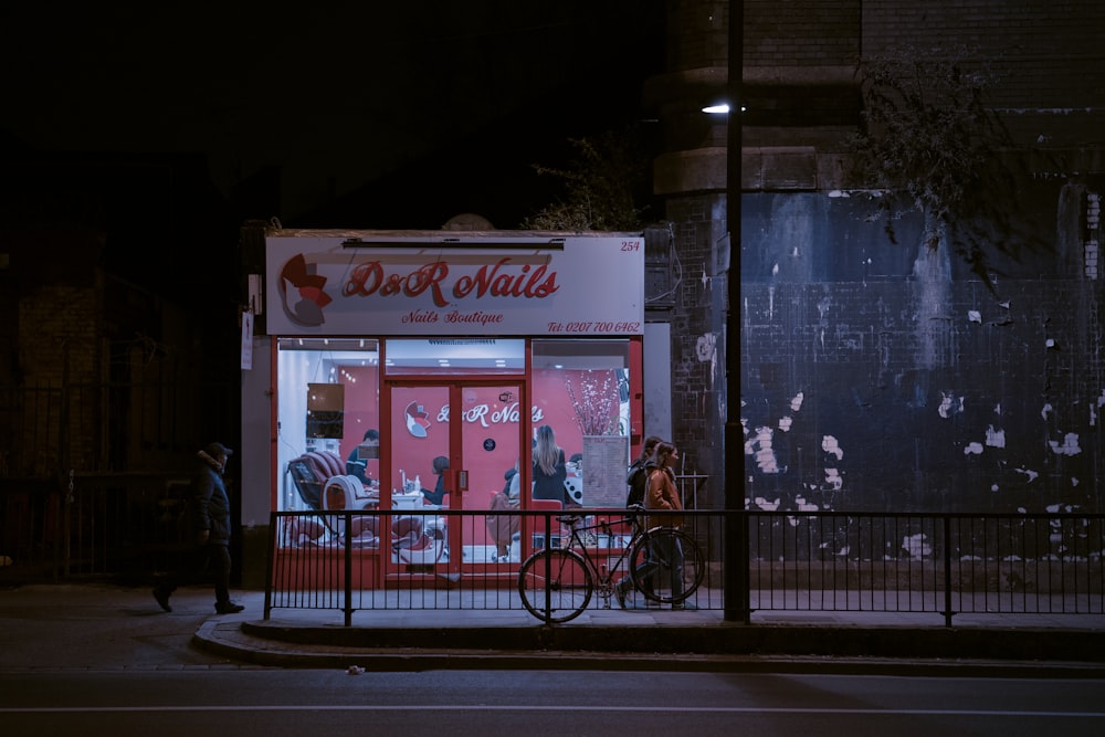 red and white store front during night time