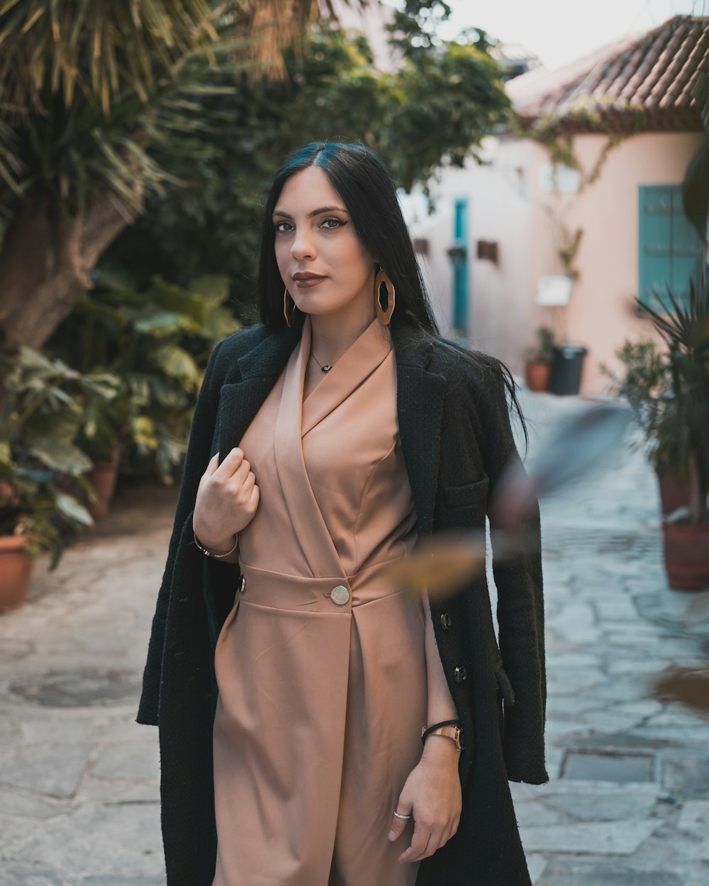 woman in black long sleeve dress standing on gray concrete floor during daytime