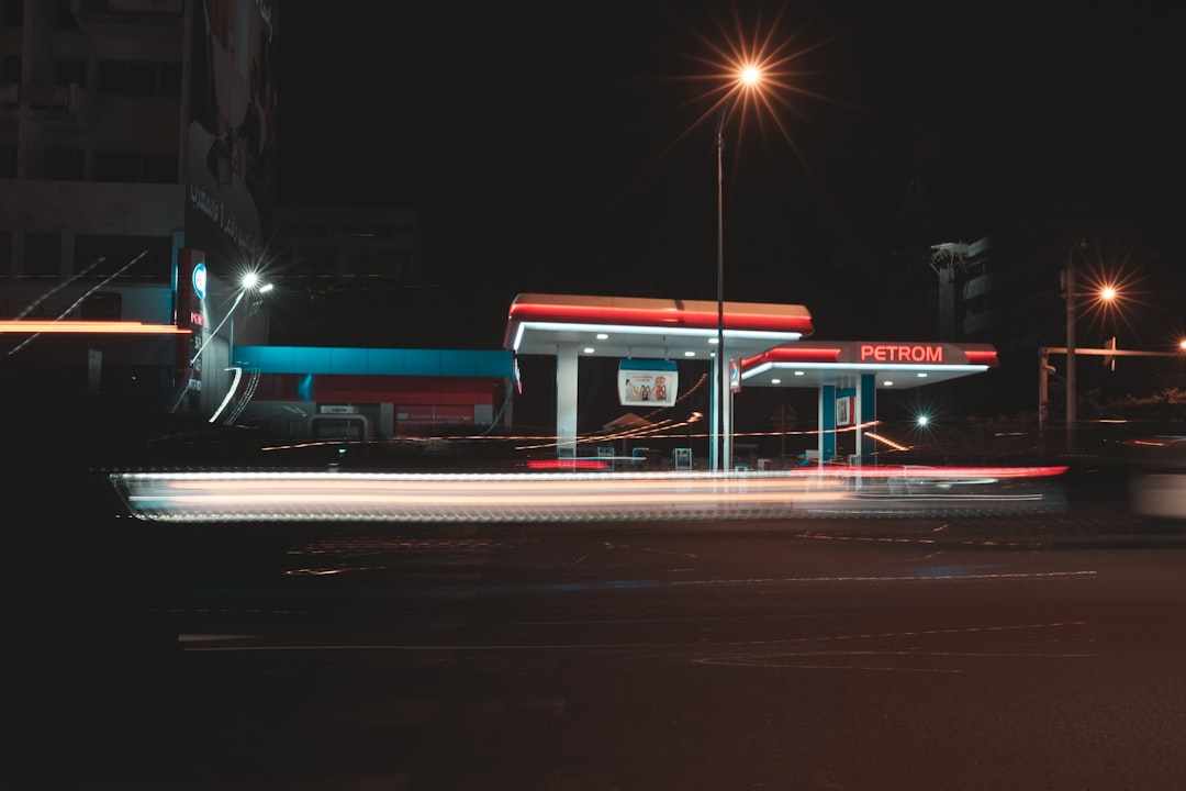 blue and red bus on road during night time