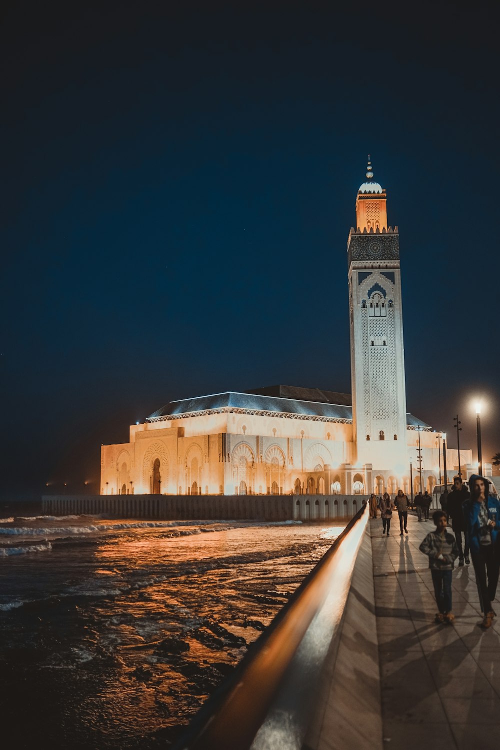 people walking near brown concrete building during night time