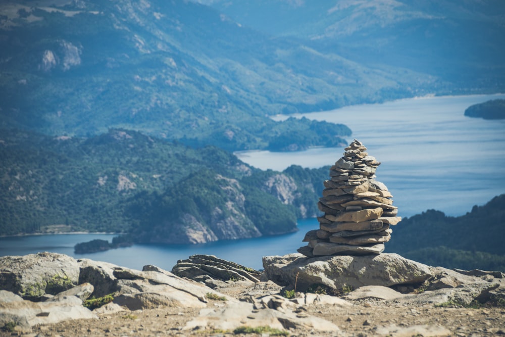 brown and gray rock formation near body of water during daytime