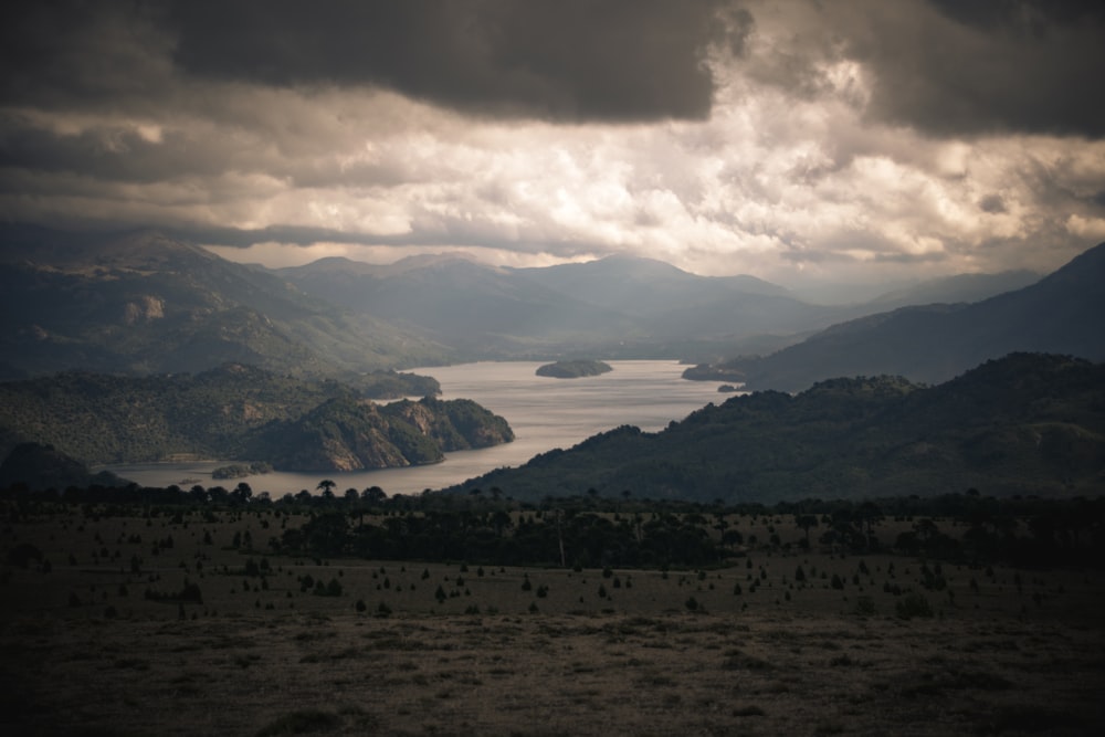 mountains and trees under white clouds during daytime