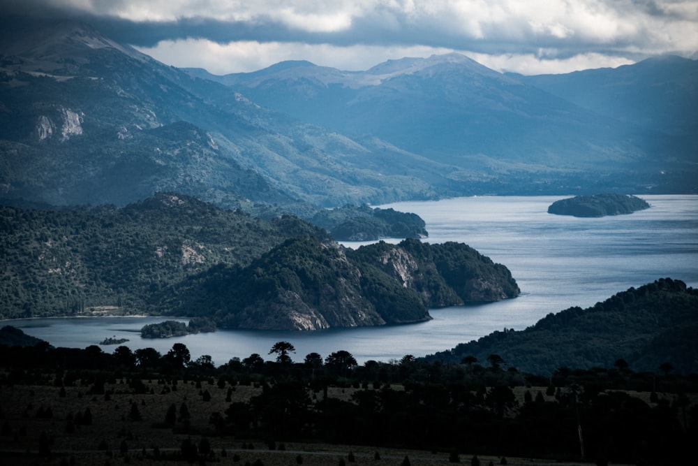 green mountains near body of water during daytime