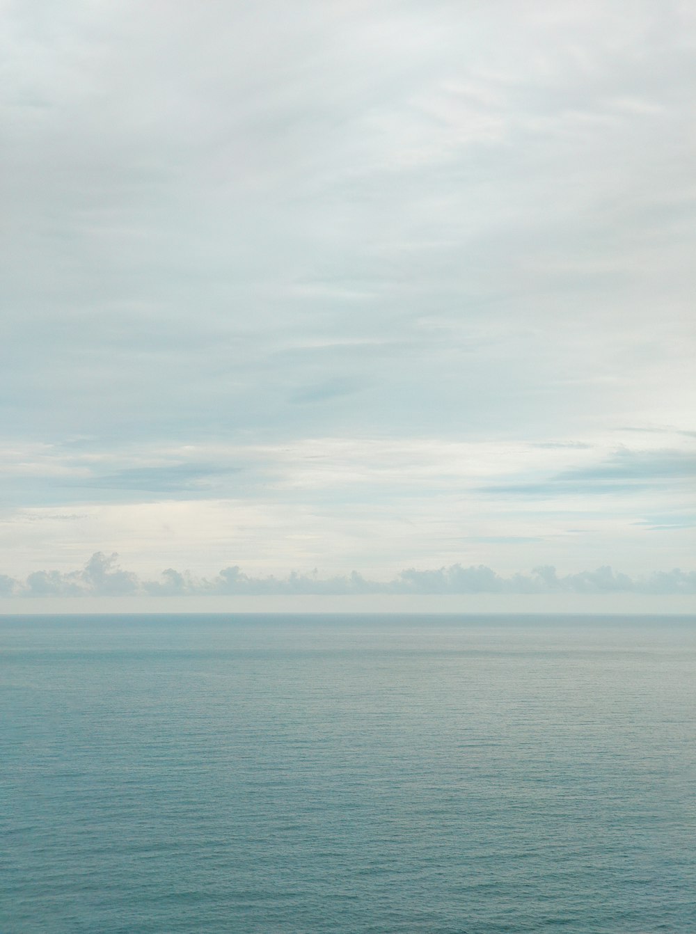 blue sea under white clouds during daytime